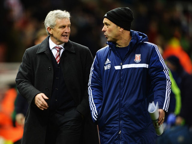 Stoke City manager Mark Hughes and his assistant Mark Bowen talk at the end of the Budweiser FA Cup third round match between Stoke City and Leicester City at the Britannia Stadium on January 4, 2014