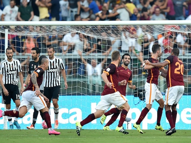 Roma's midfielder from Bosnia-Herzegovina Miralem Pjanic (2ndR) celebrates with teammates after scoring during the Italian Serie A football match AS Roma vs Juventus on August 30, 2015