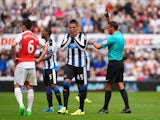 Aleksandar Mitrovic of Newcastle United is shown a red card by referee Andre Marriner (1st R) during the Barclays Premier League match between Newcastle United and Arsenal at St James' Park on August 29, 2015