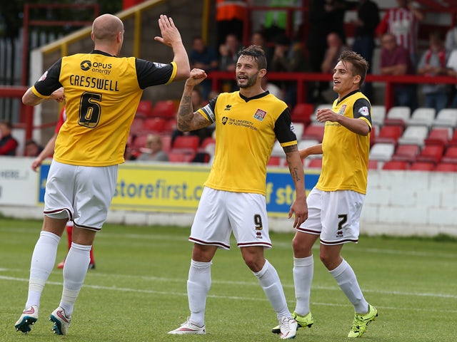 Marc Richards of Northampton Town is congratulated by team mates Ryan Cresswell and Lawson D'Ath after scoring his sides 1st goal during the Sky Bet League Two match between Accrington Stanley and Northampton Town at The Wham Stadium on August 29, 2015