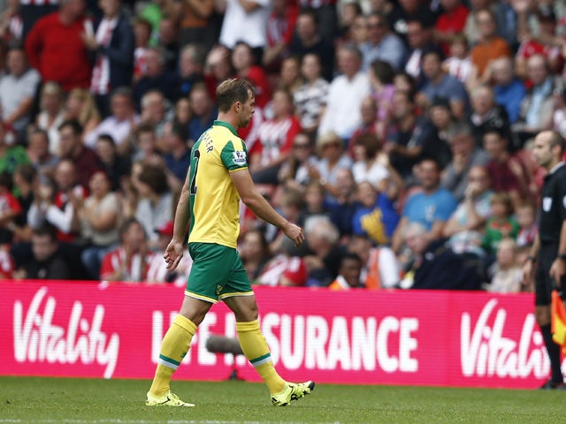Norwich City's Scottish defender Steven Whittaker walks from the pitch after receiving a red card during the English Premier League football match between Southampton and Norwich City at St Mary's Stadium in Southampton, southern England on August 30, 201