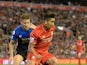 Liverpool's Brazilian midfielder Roberto Firmino (R) is challenged by Bournemouth's English defender Simon Francis during the English Premier League football match between Liverpool and Bournemouth at the Anfield stadium in Liverpool, north-west England o