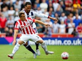 Xherdan Shaqiri of Stoke City and Joleon Lescott of West Bromwich Albion compete for the ball during the Barclays Premier League match between Stoke City and West Bromwich Albion at Britannia Stadium on August 29, 2015