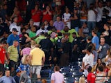 Emergency medical staff help a fan that fell from the upper deck of Turner Field during the game between the Atlanta Braves and the New York Yankees on August 29, 2015