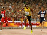 Usain Bolt of Jamaica crosses the finish line to win gold in the Men's 4x100 Metres Relay final ahead of Mike Rodgers of the United States during day eight of the 15th IAAF World Athletics Championships Beijing 2015 at Beijing National Stadium on August 2