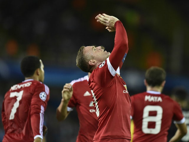 Manchester's Wayne Rooney celebrates after scoring the opening goal during the UEFA Champions League play-off round second leg football match between Club Brugge and Manchester United at Jan Breydel stadium in Bruges, Belgium on August 26