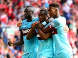 Diafra Sakho of West Ham United celebrates scoring his team's third goal with his team mates Cheikhou Kouyate and Reece Oxford during the Barclays Premier League match between Liverpool and West Ham United at Anfield on August 29, 2015