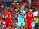 Mark Noble of West Ham United celebrates scoring his team's second goal from the penalty spot during the Barclays Premier League match between Liverpool and West Ham United at Anfield on August 29, 2015 