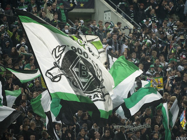Gladbach fans wave flags during the UEFA Europa League Group C football match VfL Borussia Moenchengladbach vs Olympique de Marseille in Moenchengladbach, western Germany on October 25, 2012. Moenchengladbach defeated Marseille 2-0. AFP PHOTO / ODD ANDERS