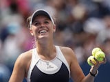 Caroline Wozniacki of Denmark hits balls to spectators after after defeating Jamie Loeb of United States during their 2015 US Open Women's Singles round 1 match at the USTA Billie Jean King National Tennis Center September 1, 2015