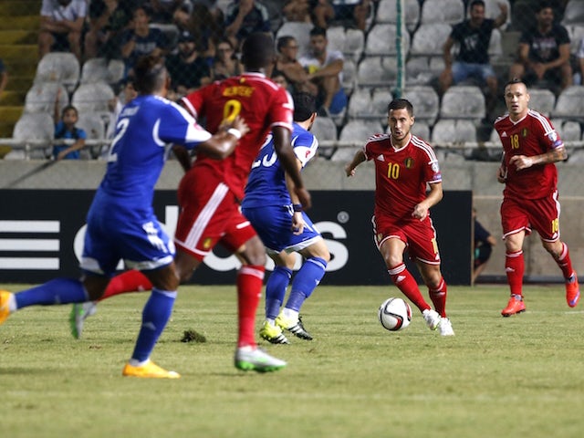 Belgium's Eden Hazard (2R) dribbles the ball towards the Cypriot defence as his teammate Radja Nainggolan (R) watches on during their EURO 2016 qualifying football match between Cyprus and Belgium at the Neo GSP stadium in the Cypriot capital, Nicosia, on