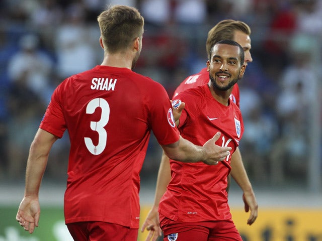 Theo Walcott (R) of England celebrates his goal with his team-mate Luke Shaw (L) during the UEFA EURO 2016 Qualifier between San Marino and England at Stadio Olimpico on September 5, 2015