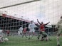 Manchester United players celebrate an own goal by Leeds United keeper Nigel Martyn (kneeling, right), during an English Premier League match at Elland Road, Leeds, 7th September 1996