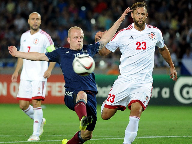 Steven Naismith (L) of Scotland vie for a ball with Levan Mchedlidze (R) of Georgia during their Euro 2016 qualifying football match between Georgia and Scotland in Tbilisi on September 4, 2015