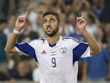 Israel's forward Munas Dabbur reacts following scoring a goal against Andorra's defender Ildefons Lima (R) during their Euro 2016 qualifying football match against Israel at the Sammy Ofer Stadium in the Israeli coastal city of Haifa on September 3, 2015