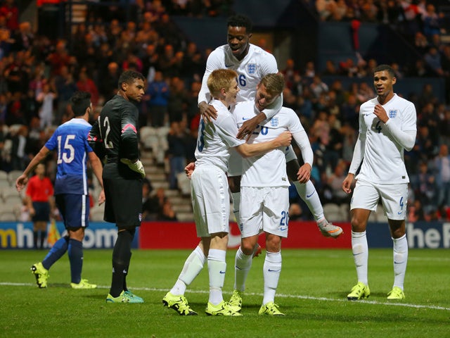 James Wilson of England celebrates with Duncan Watmore and Nathaniel Chalobah of England, (top) after scoring the first goal of the game during the International friendly match between England U21 and USA U23 at Deepdale on September 3, 2015 