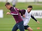 John Stones is challenged by Ryan Mason during an England training session on September 2, 2015