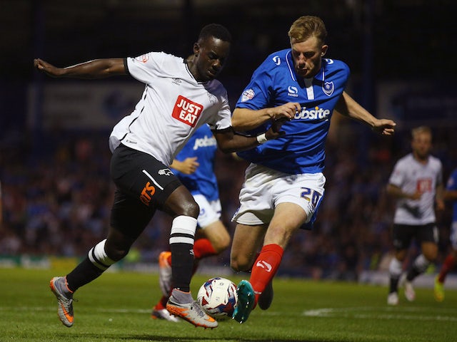 Matt Clarke of Portsmouth tries to tackle Simon Dawkins of Derby County during the Capital One Cup First Round match between Portsmouth v Derby County at Fratton Park on August 12, 2015 in Portsmouth, England. (Photo by Ian Walton/Getty Images)