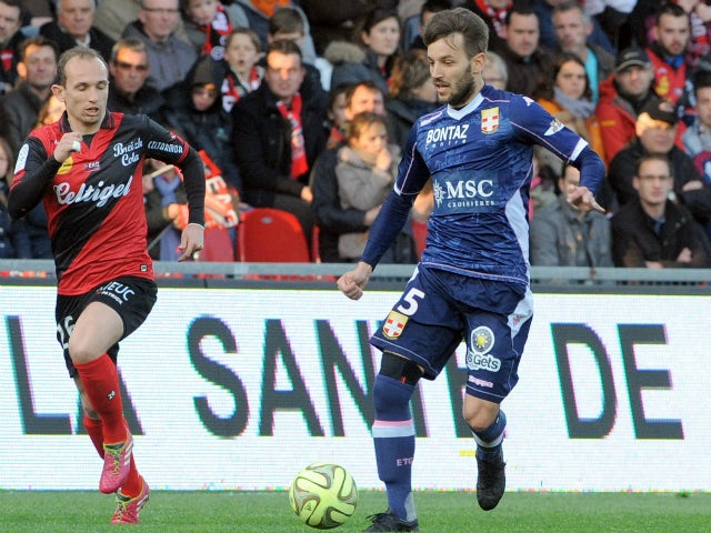 Guingamp's French forward Thibault Giresse (L) vies with Evian's midfielder Milos Ninkovic during the French L1 football match between Guingamp and Evian on April 18, 2015 at the Roudourou stadium in Guingamp, western of France.