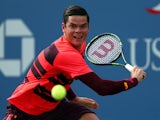 Milos Raonic return a shot against Tim Smyczek of the United States during their Men's Singles First Round match on Day One of the 2015 US Open at the USTA Billie Jean King National Tennis Center on August 31, 2015