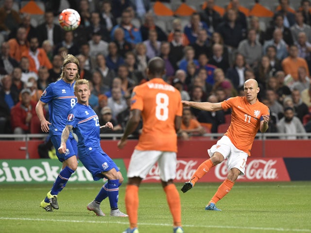Netherlands' Arjen Robben (R) shoots the ball during the Euro 2016 qualifying round football match between Netherlands and Iceland at the Arena Stadium, on September 3, 2015
