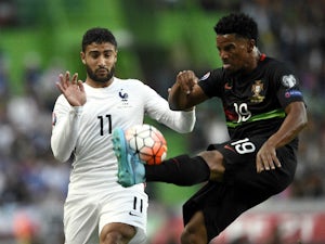 France's forward Nabil Fekir (L) vies with Portugal's defender Eliseu during the Euro 2016 friendly football match Portugal vs France at the Jose Alvalade stadium in Lisbon on September 4, 2015.