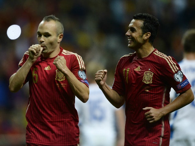 Spain's midfielder Andres Iniesta (L) celebrates with Spain's forward Pedro Rodriguez after scoring a goal during the Euro 2016 qualifying football match Spain vs Slovakia at the Carlos Tartiere stadium in Oviedo on September 5, 2015.