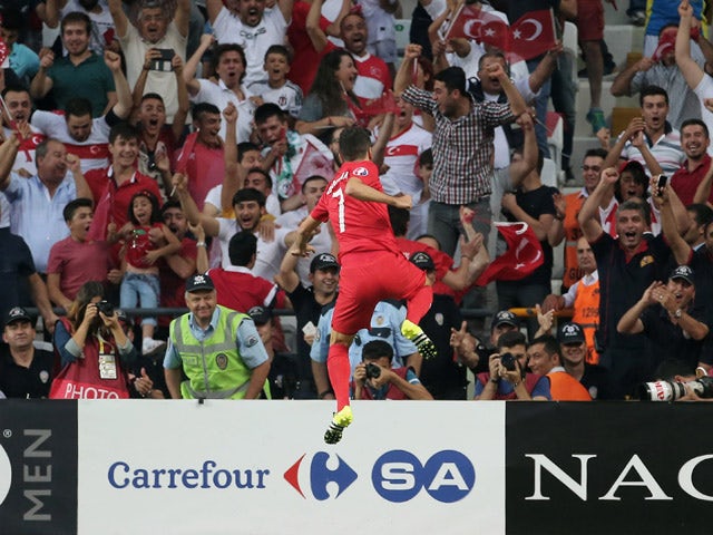 Turkey's midfielder Oguzhan Ozyakup celebrates after scoring a goal against Netherlands during the Euro 2016 qualifying football match between Turkey and Netherlands at the Arena Stadium in Konya, on September 6, 2015