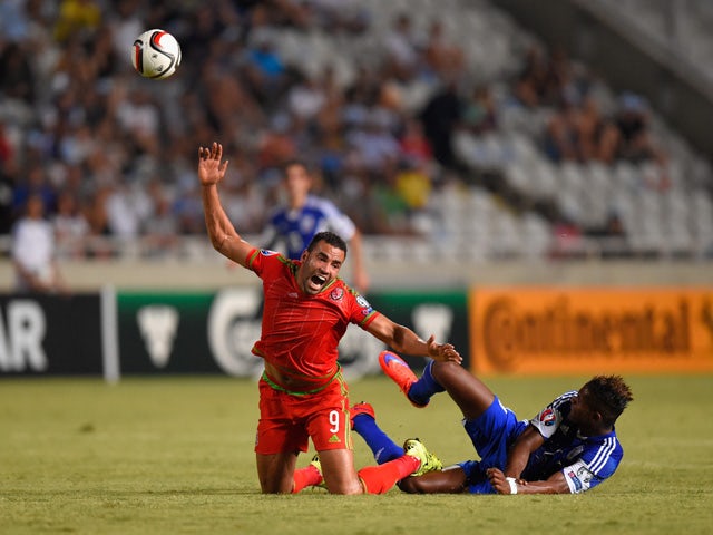 Wales player Hal Robson-Kanu is challenged by Dossa Junior of Cyprus during the UEFA EURO 2016 Qualifier between Cyprus and Wales at GPS Stadium on September 3, 2015