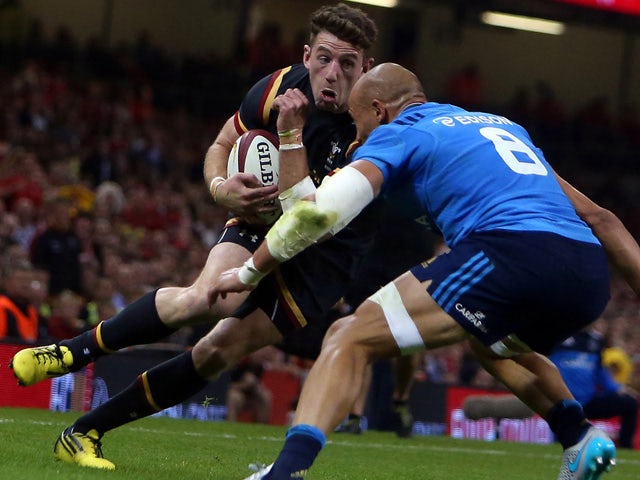 Wales' wing Alex Cuthbert (L) runs at the Italian captain Sergio Parisse (R) during the international rugby union friendly match between Wales and Italy, ahead of the 2015 Rugby World Cup, at The Millennium Stadium in Cardiff, south Wales, on September 5,