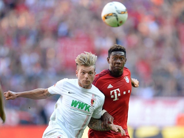 Augsburg's Alexander Esswein battles with David Alaba of Bayern Munich on September 12, 2015