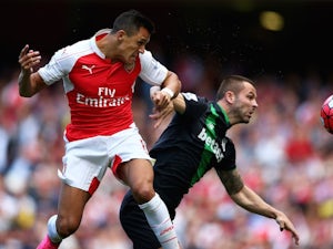 Alexis Sanchez and Phil Bardsley tussle during the game between Arsenal and Stoke on September 12, 2015