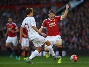 Man Utd's Bastian Schweinsteiger closes down Lucas Leiva of Liverpool on September 12, 2015