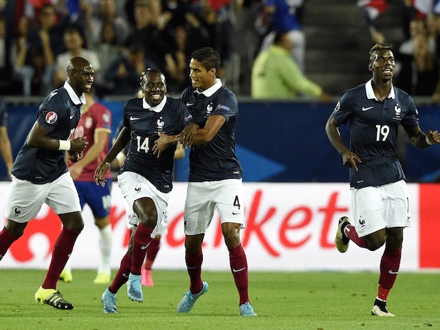 France's midfielder Blaise Matuidi (C) celebrates with France's defender Raphael Varane (2nd R) after scoring during the Euro 2016 friendly football match France vs Serbia at the Matmut Atlantique stadium in Bordeaux on September 7, 2015.