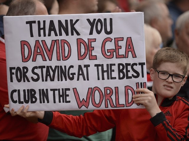 A young Manchester United fan looks slightly disgusted while showing his gratitude for David de Gea on September 12, 2015
