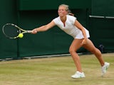 Emily Arbuthnott of Great Britain plays a forehand in her Girl's Singles First Round match against Olivia Tjandramulia of Australia during day seven of the Wimbledon Lawn Tennis Championships at the All England Lawn Tennis and Croquet Club on July 6, 2015