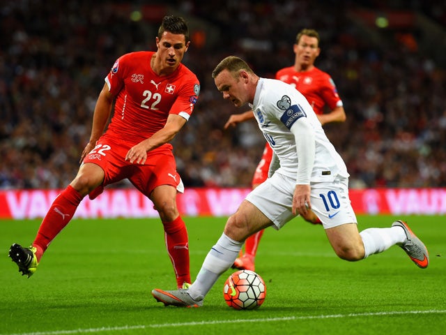 Wayne Rooney of England is marshalled by Fabian Schar of Switzerland during the UEFA EURO 2016 Group E qualifying match between England and Switzerland at Wembley Stadium on September 8, 2015