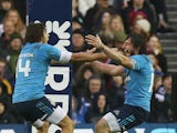 Italy's wing Michele Visentin (L) and Italy's centre Enrico Bacchin celebrate at full time in the Six Nations international rugby union match between Scotland and Italy at Murrayfield in Edinburgh, Scotland on February 28, 2015