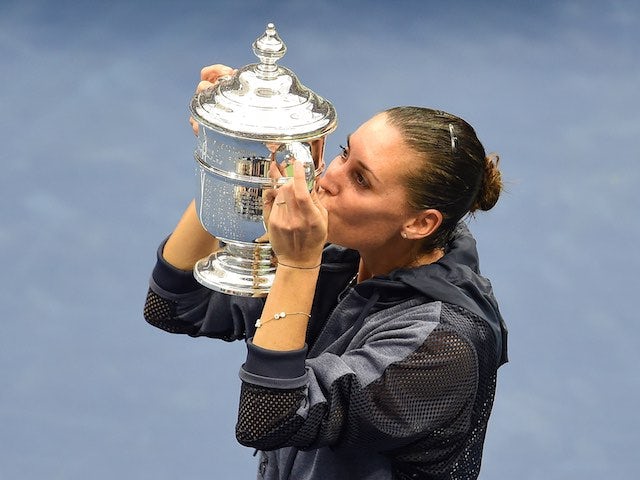 Flavia Pennetta kisses her US Open trophy after defeating Roberta Vinci on September 12, 2015