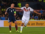 Germany's midfielder Ilkay Gundogan (R) celebrates after scoring their third goal as Scotland's midfielder Scott Brown reacts behind during the Euro 2016 qualifying group D football match between Scotland and Germany at Hampden Park in Glasgow on Septembe
