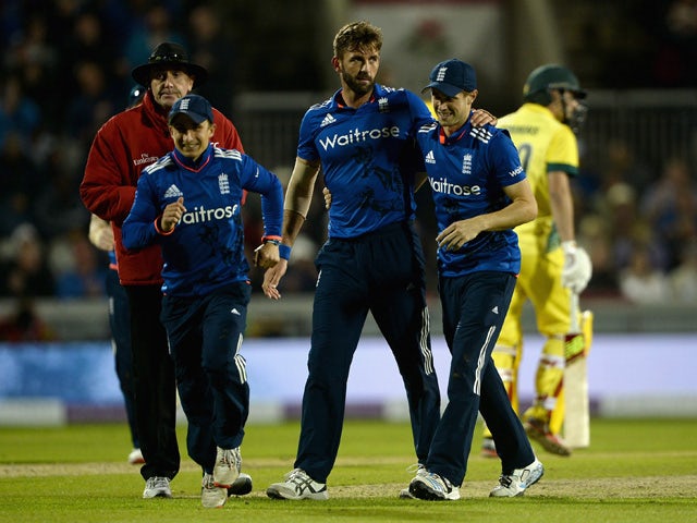 Liam Plunkett of England celebrates with James Taylor and Chris Woakes after dismissing Pat Cummins of Australia during the 3rd Royal London One-Day International match between England and Australia at Old Trafford on September 8, 2015