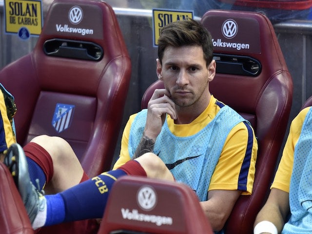 Lionel Messi watches on from the bench as Barcelona take on Atletico Madrid on September 12, 2015