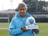 Silver fox Manuel Pellegrini poses proudly with his Manager of the Month award for August 2015