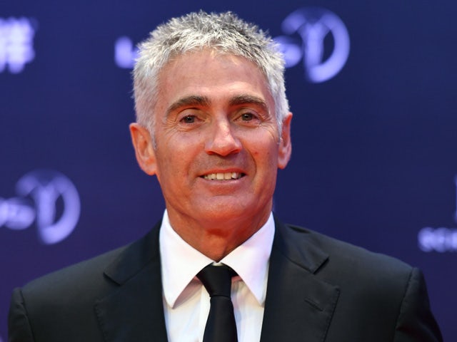 Former MotoGP driver Mick Doohan poses on the red carpet as he arrives ahead of the Laureus World Sports Award ceremony at the Grand Theater in Shanghai on April 15, 2015