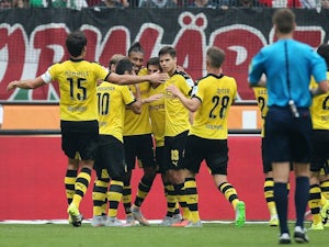 Pierre-Emerick Aubameyang is congratulated by teammates after scoring Dortmund's equaliser against Hannover on September 12, 2015