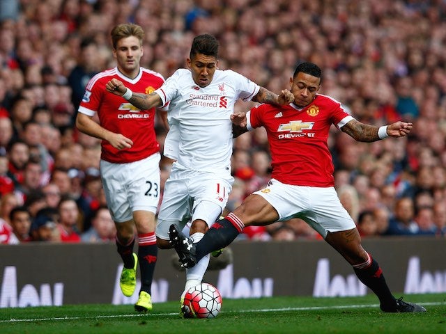 Liverpool's Roberto Firmino and Man Utd's Memphis Depay tussle on September 12, 2015