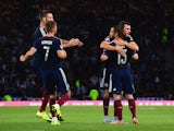 Shaun Maloney of Scotland celebrates the own goal scored by Mats Hummels of Germany with team mates during the UEFA EURO 2016 Qualifier Group D match between Scotland and Germany at Hampden Park on September 7, 2015 in Glasgow, Scotland.