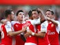 Theo Walcott is congratulated by teammates after scoring Arsenal's opener against Stoke on September 12, 2015