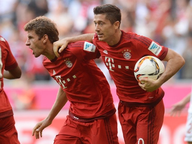 Thomas Muller and Robert Lewandowski celebrate Bayern's equaliser against Augsburg on September 12, 2015