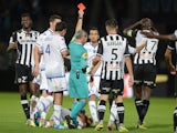 French referee Lionel Jaffred gives a red card to Angers' Senegalese midfielder Cheikh N'Doye (R) during the French L1 football match between Angers and Troyes on September 19, 2015